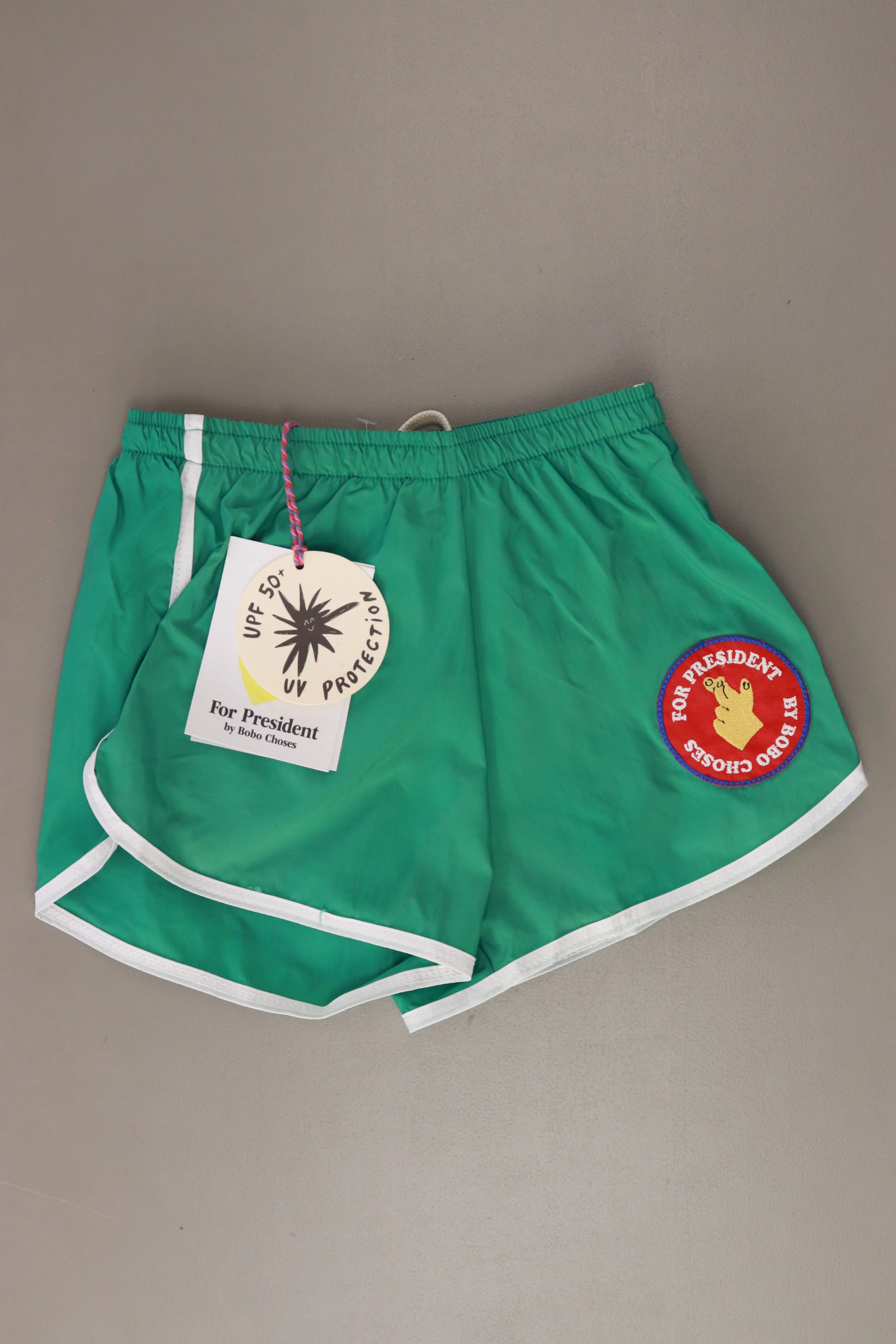 Bobo Choses Kinder Schwimmshorts "Fingers Crossed" grün Größe 6 - 7 Jahre, 122 cm neu mit Etikett